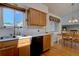 Bright kitchen featuring light wood cabinets, stainless steel sink, and hardwood floors at 2195 S Espana St, Aurora, CO 80013