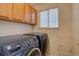 Convenient laundry room featuring modern appliances and storage space at 2195 S Espana St, Aurora, CO 80013