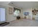 Bright living room featuring neutral carpet, built-in shelving, and ample natural light from the window at 2195 S Espana St, Aurora, CO 80013