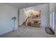 Inviting living room with view of the open floor plan, staircase, and natural light at 2195 S Espana St, Aurora, CO 80013