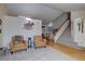 Open concept living room featuring a fireplace, staircase, and hardwood floors at 2195 S Espana St, Aurora, CO 80013