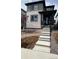 Two-story home featuring a mix of stone and gray siding and a welcoming front porch at 7360 Watercress Dr, Littleton, CO 80125