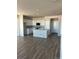 Bright kitchen featuring an island, stainless appliances, white cabinets, and hardwood floors at 7360 Watercress Dr, Littleton, CO 80125