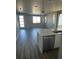 Stainless dishwasher next to a kitchen island with an open layout and hardwood floors at 7360 Watercress Dr, Littleton, CO 80125