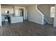 Open concept kitchen with gray cabinets, stainless steel appliances, and hardwood floors at 7360 Watercress Dr, Littleton, CO 80125