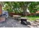 Backyard patio with a fire pit, barbecue, and dining area at 3779 Quitman St, Denver, CO 80212