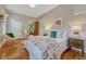 Inviting bedroom showcases a floral comforter, hardwood floors, and bright natural light at 3779 Quitman St, Denver, CO 80212
