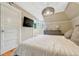 Bright bedroom with a queen bed, TV, a modern chandelier, and lots of natural light at 3779 Quitman St, Denver, CO 80212