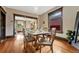 Charming dining room with hardwood floors, farm table, and view into living area at 3779 Quitman St, Denver, CO 80212