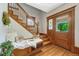 Entryway featuring a wooden staircase, bench with pillows, and stained-glass door at 3779 Quitman St, Denver, CO 80212