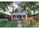 Charming two-story home featuring a red brick facade, front porch, and balcony at 3779 Quitman St, Denver, CO 80212