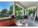 Inviting covered front porch with rocking chairs and brick accents at 3779 Quitman St, Denver, CO 80212