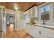 Lovely kitchen boasts bright lighting, white cabinets, and stainless steel appliances at 3779 Quitman St, Denver, CO 80212