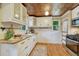 Charming kitchen with white cabinets, stainless steel appliances, and butcher block countertops at 3779 Quitman St, Denver, CO 80212