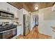 This beautiful kitchen features white cabinets, stainless steel appliances, and hardwood floors at 3779 Quitman St, Denver, CO 80212
