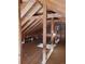 Unfinished attic space showing rafters and beams at 2061 E Floyd Ave, Englewood, CO 80113