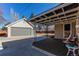 Covered patio with seating area and adjacent garage, perfect for outdoor relaxation and entertainment at 2061 E Floyd Ave, Englewood, CO 80113