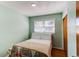 A cozy bedroom with a light green paint, a window, and a double bed at 2061 E Floyd Ave, Englewood, CO 80113