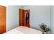 This bedroom has hardwood floors, light blue walls and an open doorway at 2061 E Floyd Ave, Englewood, CO 80113