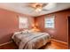 Well-lit bedroom featuring hardwood floors, soft lighting and two windows with natural light at 2061 E Floyd Ave, Englewood, CO 80113