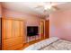 Bright bedroom featuring hardwood floors, ample storage, ceiling fan and natural light at 2061 E Floyd Ave, Englewood, CO 80113