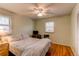 Cozy bedroom with light green walls, a ceiling fan, hardwood floors and natural light at 2061 E Floyd Ave, Englewood, CO 80113