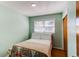 Serene bedroom with soft green walls, hardwood floors, a window and a closet at 2061 E Floyd Ave, Englewood, CO 80113
