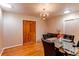 This dining room features hardwood floors, a modern chandelier and a dining set for four at 2061 E Floyd Ave, Englewood, CO 80113
