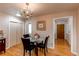 Bright dining room features hardwood floors, modern lighting, and a glass-topped dining table at 2061 E Floyd Ave, Englewood, CO 80113