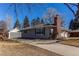 Side view of house and detached garage with long driveway at 2061 E Floyd Ave, Englewood, CO 80113