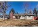 Charming exterior with a brick chimney and well-maintained lawn at 2061 E Floyd Ave, Englewood, CO 80113