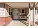 Inviting covered front porch with a cozy bench and decorative accents at 2061 E Floyd Ave, Englewood, CO 80113