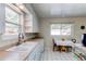 Bright kitchen with a classic design, featuring white cabinets, and a cozy breakfast nook at 2061 E Floyd Ave, Englewood, CO 80113
