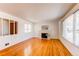 Bright living room features hardwood floors, a fireplace, and large windows offering ample natural light at 2061 E Floyd Ave, Englewood, CO 80113