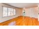 Spacious living room boasting beautiful hardwood floors, natural light, and a doorway to the kitchen at 2061 E Floyd Ave, Englewood, CO 80113
