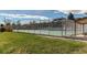 Outdoor community tennis court surrounded by a chain-link fence and green space at 2061 E Floyd Ave, Englewood, CO 80113