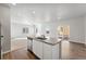 Bright kitchen with an island and an adjoining living room at 2973 Oxley St, Strasburg, CO 80136