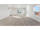 Bright living room with soft carpet and ample windows allowing natural light to fill the space at 2973 Oxley St, Strasburg, CO 80136