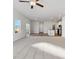 Bright living room with modern ceiling fan and large windows allowing ample natural light to illuminate the space at 2973 Oxley St, Strasburg, CO 80136