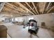 Unfinished basement with exposed duct work, a treadmill, and two bright windows providing natural light at 1481 Red Poppy Way, Brighton, CO 80601