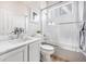 Bright bathroom featuring a shower-tub combo, white tiled herring bone shower, and marble countertop vanity at 1481 Red Poppy Way, Brighton, CO 80601
