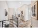 Bright hallway featuring wood floors, iron railings, and stylish decor at 1481 Red Poppy Way, Brighton, CO 80601