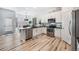 Bright kitchen with white cabinets, stainless steel appliances, a stylish brick backsplash and breakfast nook at 1481 Red Poppy Way, Brighton, CO 80601