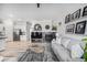 Open floor plan featuring a stone fireplace, modern decor, and seamless flow to the kitchen at 1481 Red Poppy Way, Brighton, CO 80601