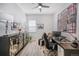 Home office featuring a ceiling fan, a modern desk with a black office chair, and stylish decorative storage at 1481 Red Poppy Way, Brighton, CO 80601