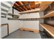 Unfinished basement with shelving, wood ceiling beams and concrete floor offers lots of storage at 12408 E Ohio Ave, Aurora, CO 80012