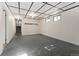 Unfinished basement with stairs, two windows, and drop ceiling offers lots of potential at 12408 E Ohio Ave, Aurora, CO 80012