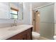 Updated bathroom with a modern vanity, large mirror, and a glass-enclosed shower at 12408 E Ohio Ave, Aurora, CO 80012
