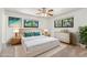 Serene bedroom features a white platform bed, soft rug, and natural light from two windows at 12408 E Ohio Ave, Aurora, CO 80012