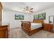 Cozy bedroom with wood furniture, a ceiling fan, and natural light from the windows at 12408 E Ohio Ave, Aurora, CO 80012